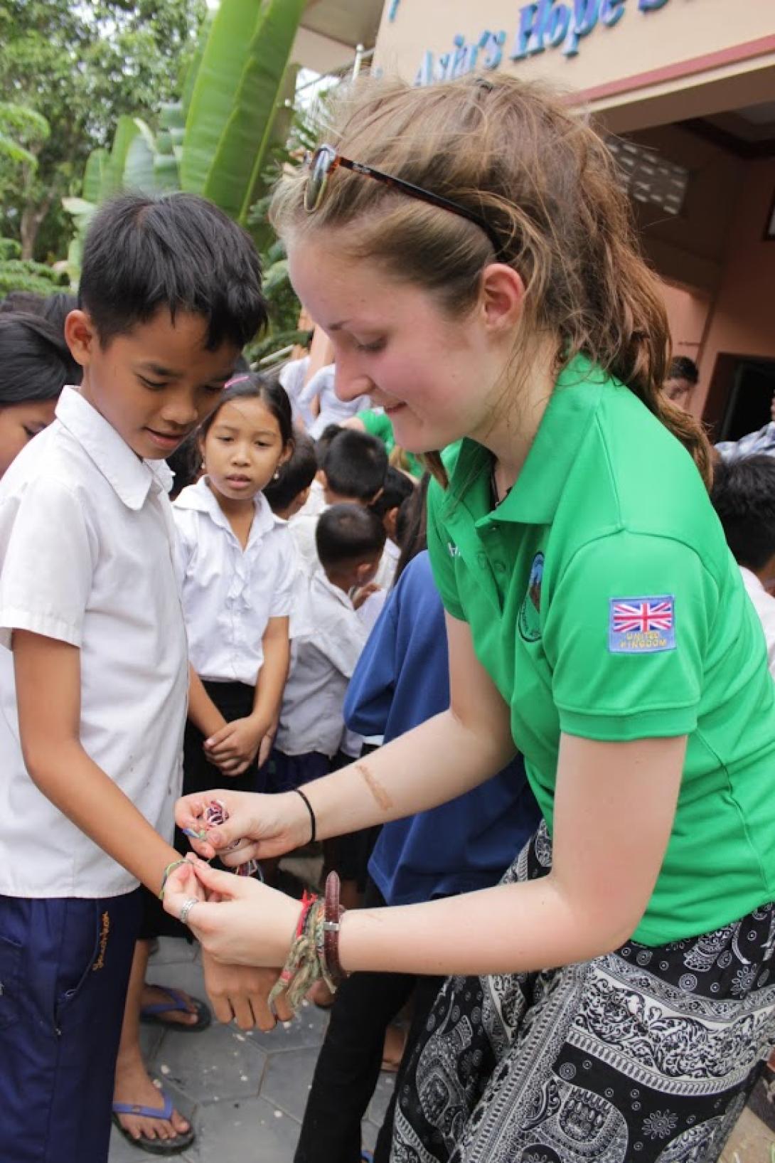 Girl guide volunteer with children in Cambodia