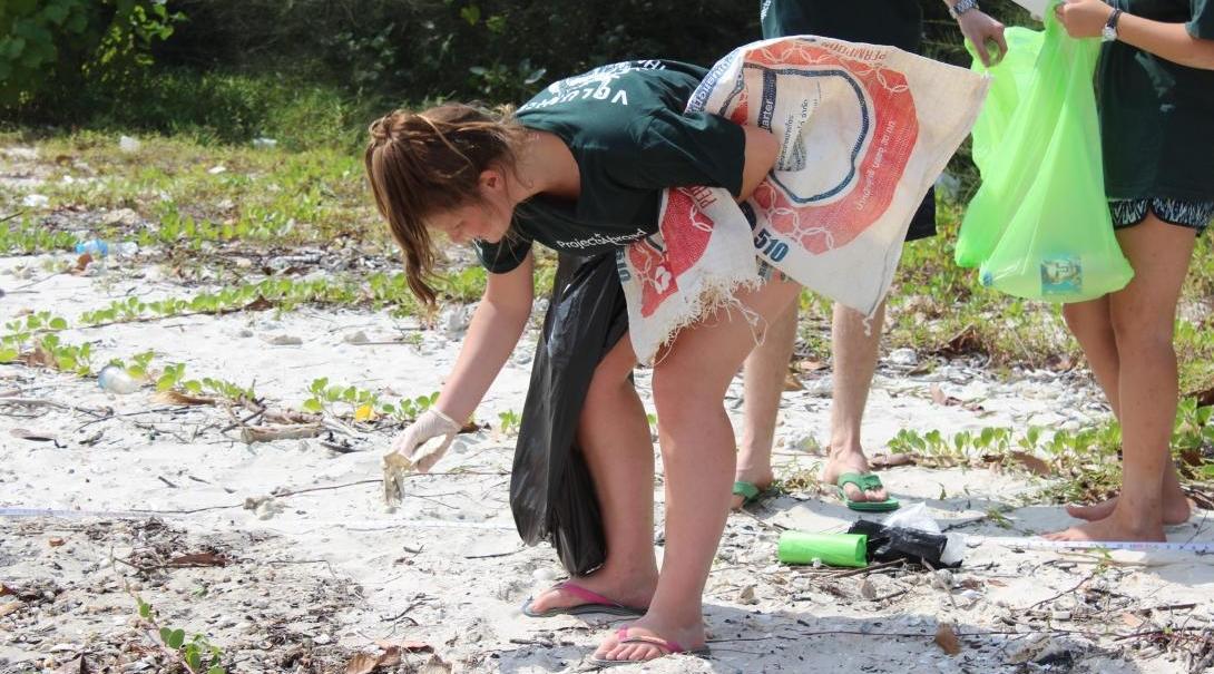 Conservation volunteer cleaning the beach