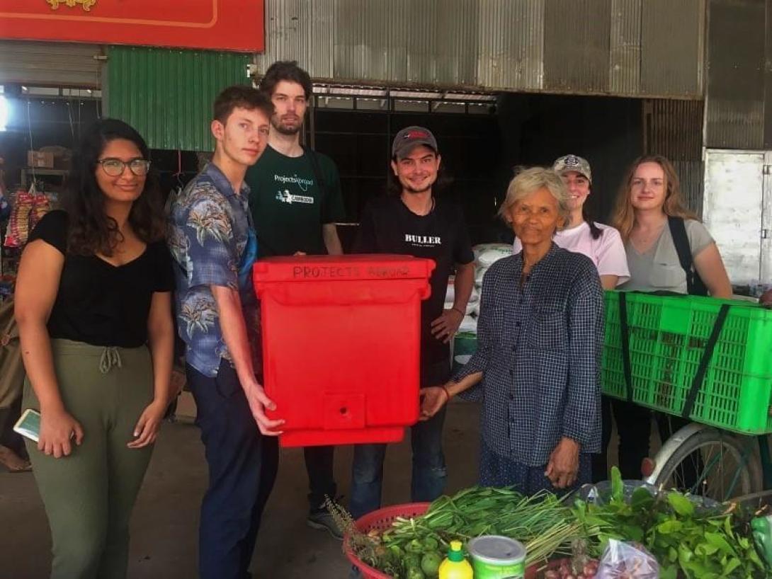 A group of Micro-finance interns abroad in Cambodia donate an ice box to a beneficiary on Silk Island 