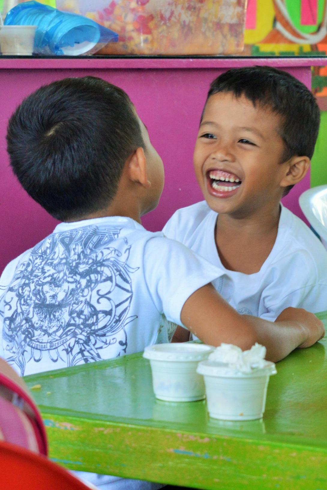 Children in Philippines smiling at each other