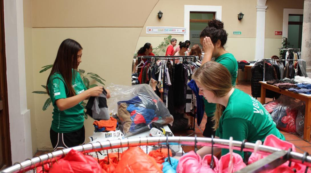 Volunteers sort clothes at the migrant center