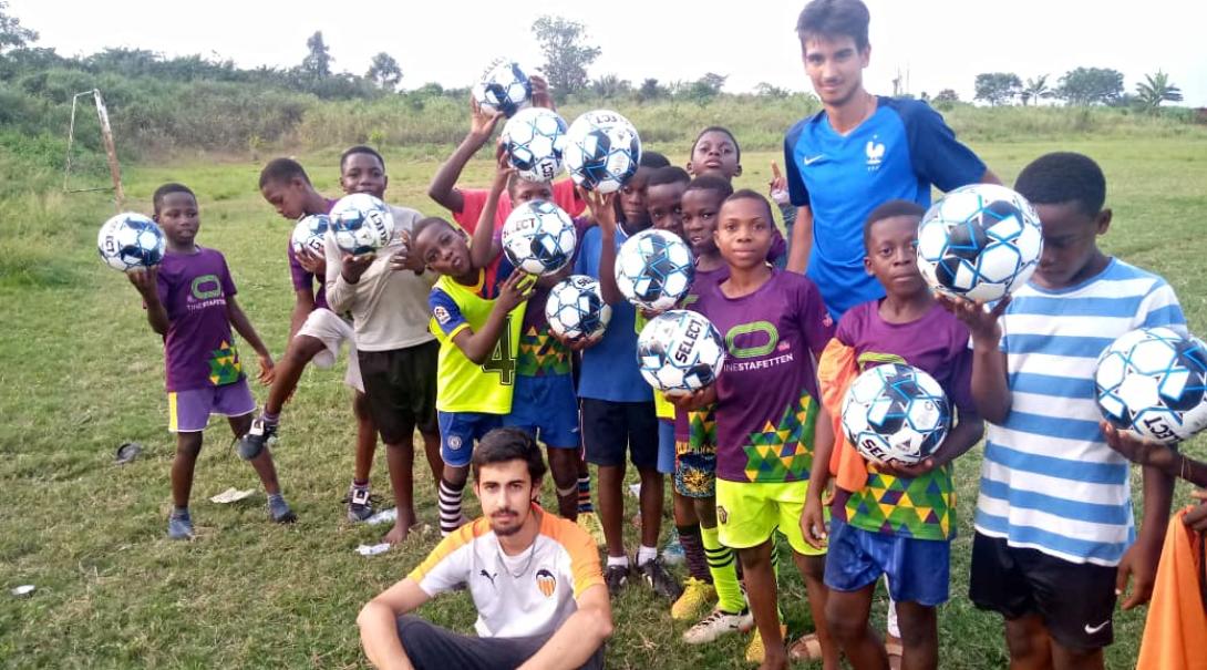 Soccer coaching volunteers with children in Ghana