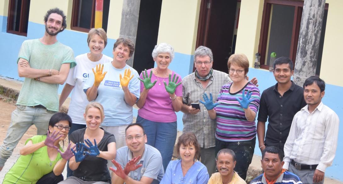 A group of Grown-up Special volunteers finish painting