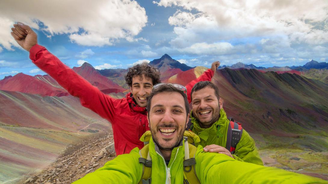 Hikers take a selfie in the Rainbow Mountains of Peru.