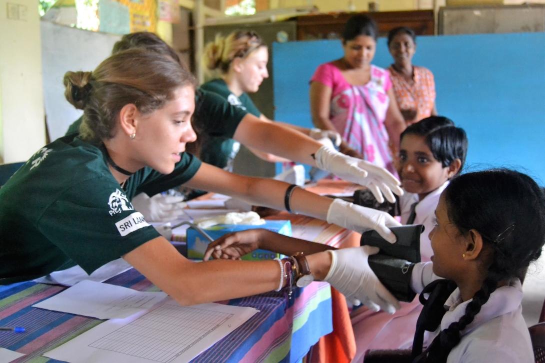 Public Health volunteer doing basic checks during a medical outreach.