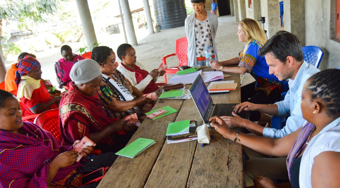 A group of local women get business advice and support from Microfinance interns in Tanzania.