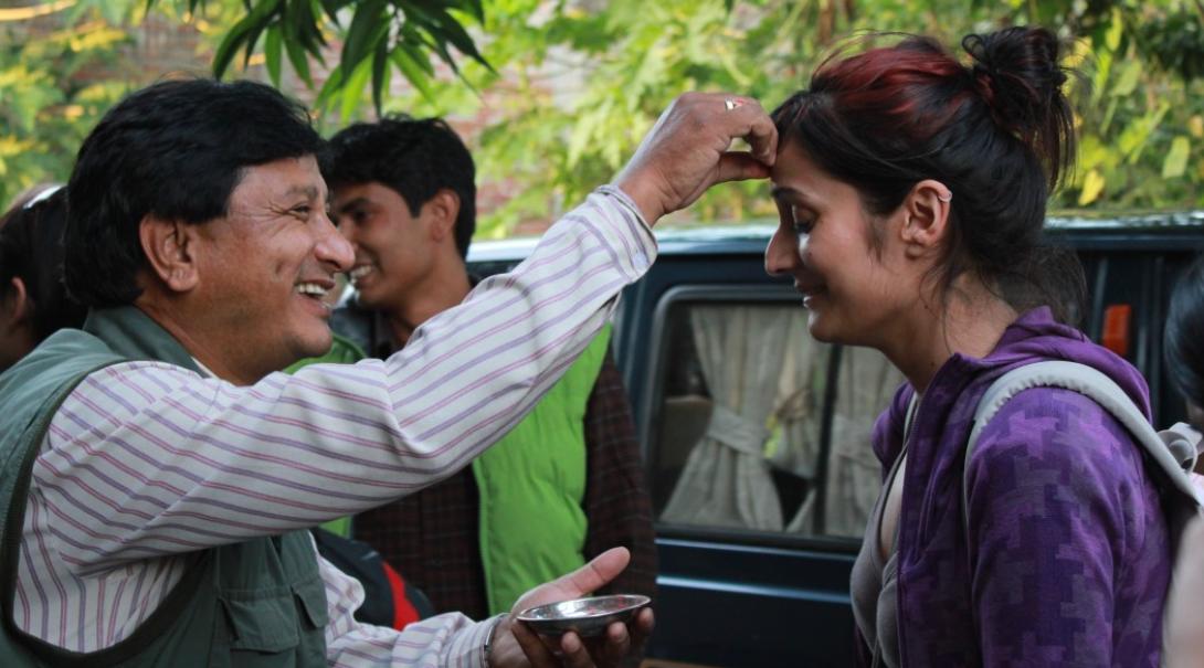 A volunteer receiving a bindi from locals
