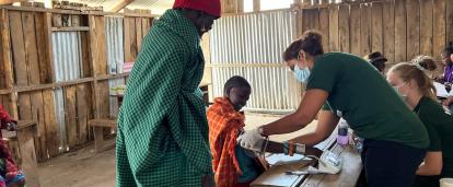 A nutrition intern in Kenya checking blood pressure