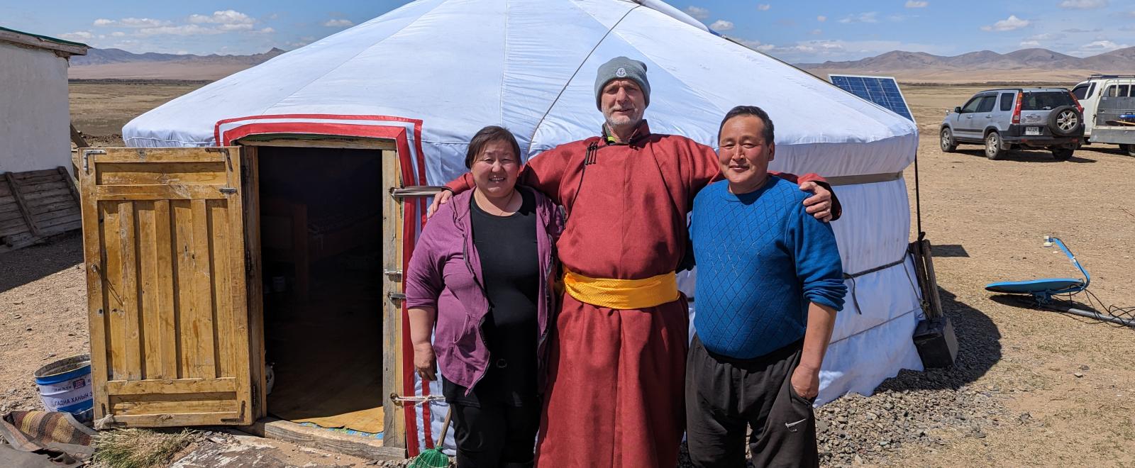 Older volunteer Stefan with his host parents in Mongolia