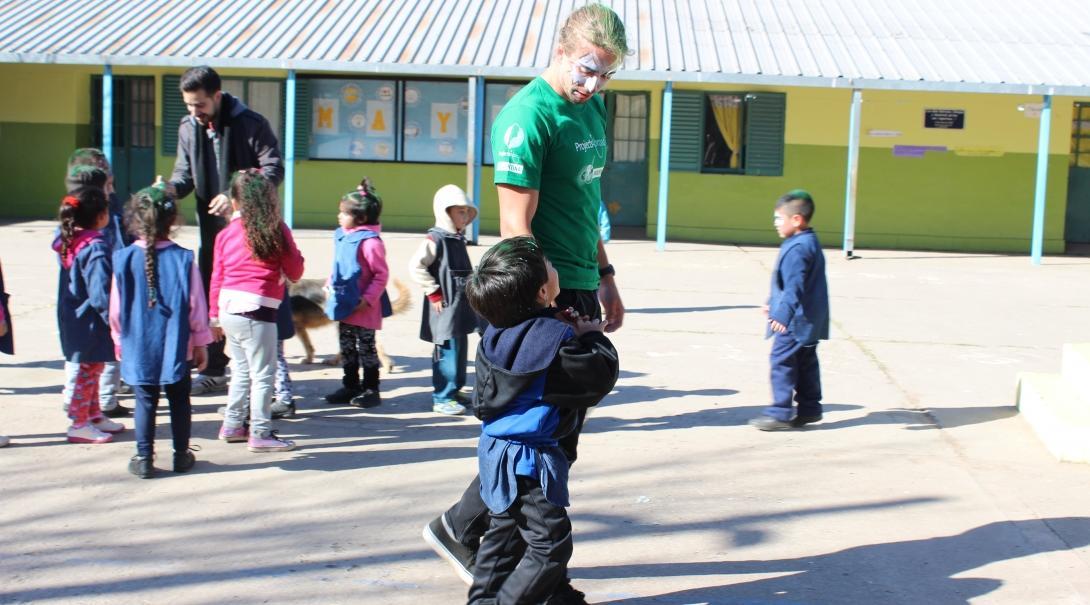 A child talks to a Projects Abroad Childcare volunteer during an outdoor activity at a kindergarten in Argentina. 