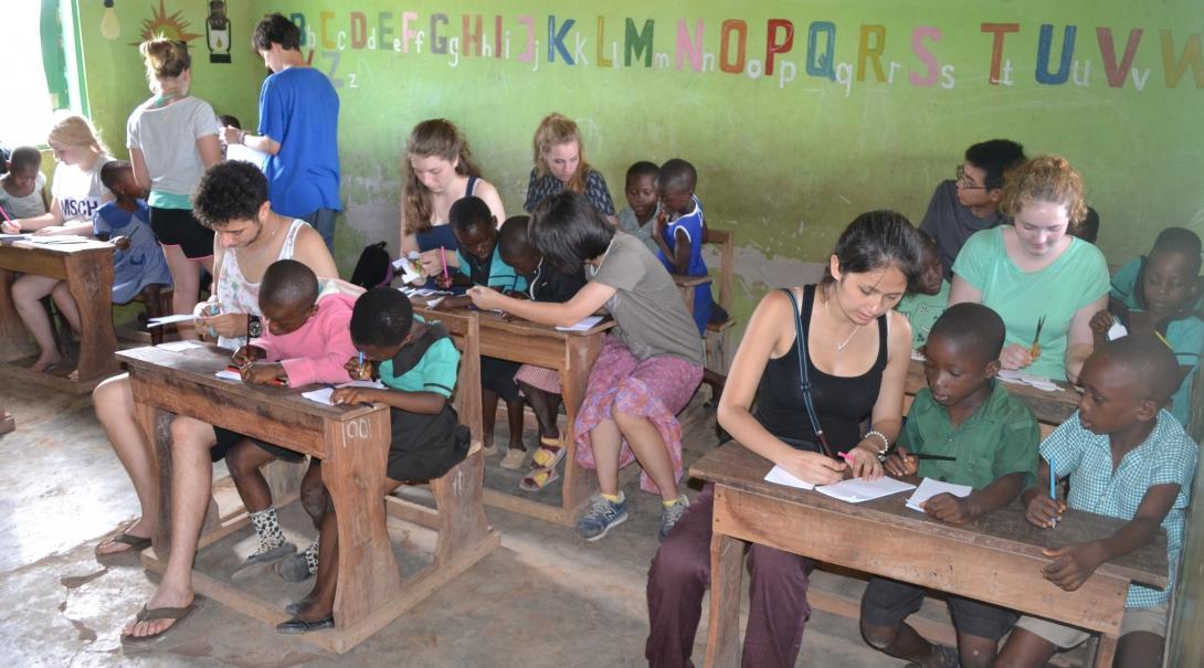 Projects Abroad volunteers help kindergarten children in Ghana with crafts activities at a local school. 