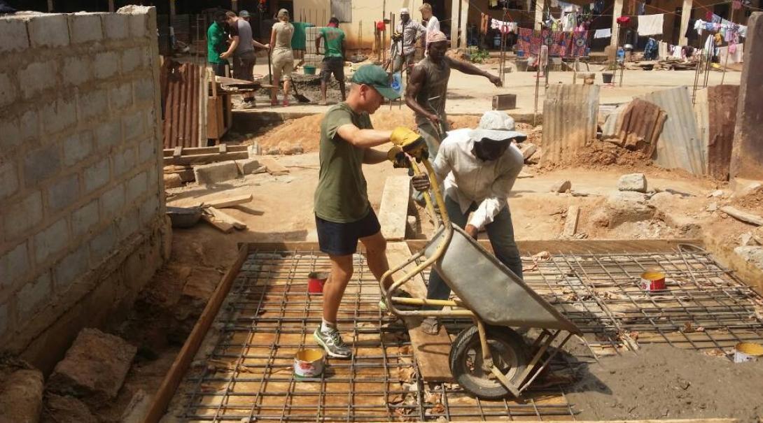 A volunteer is pictured laying the foundations for a toilet block as part of his building volunteer work in Ghana.