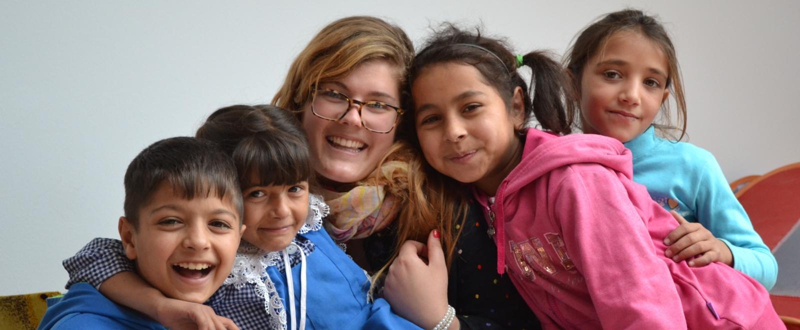 Female volunteer working with children in Romania at a care centre for her Childcare Project.