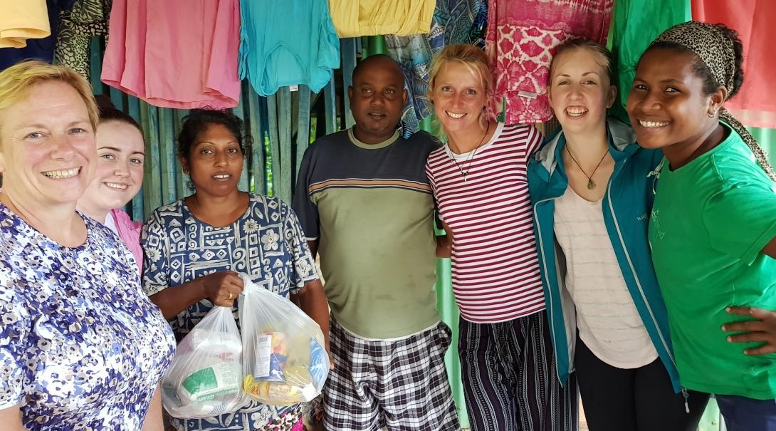 Female Community Volunteers pose with a local couple at a Community Day during Cultural Immersion in Fiji.