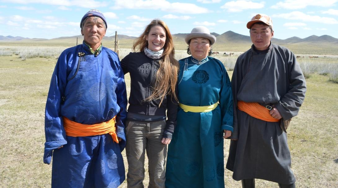 Female Culture and Community Volunteer poses with Mongolian Nomads during a Volunteering project.