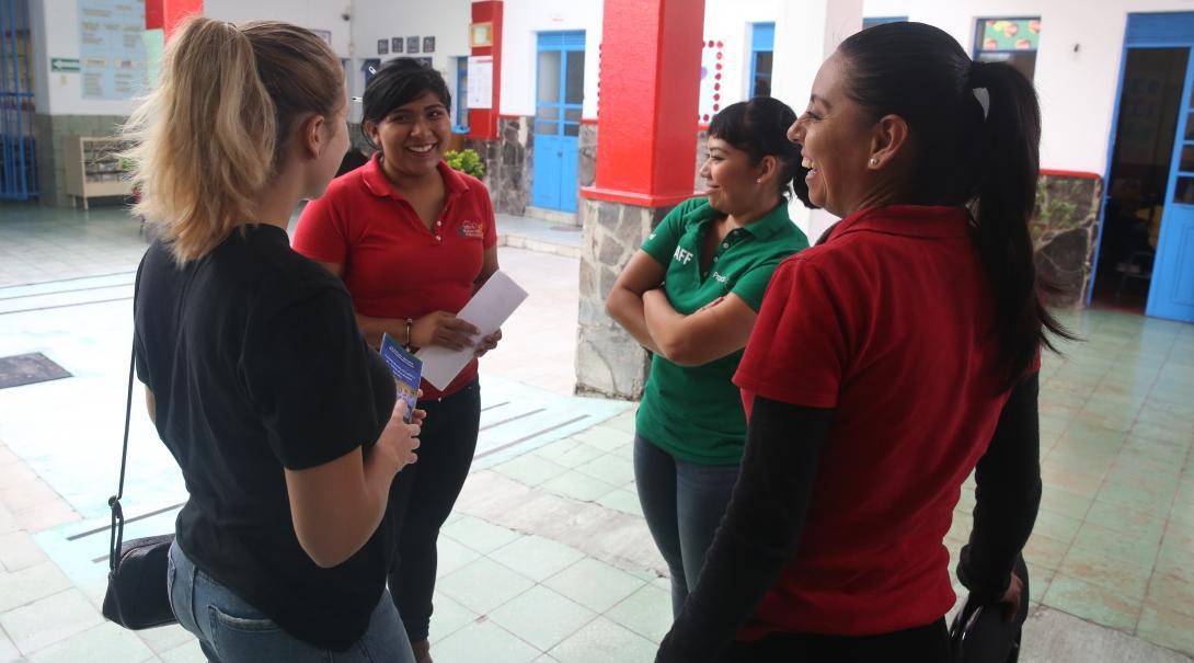 Female International Development interns stand in Day Centre prior to their progress meeting during their internship in Mexico. 