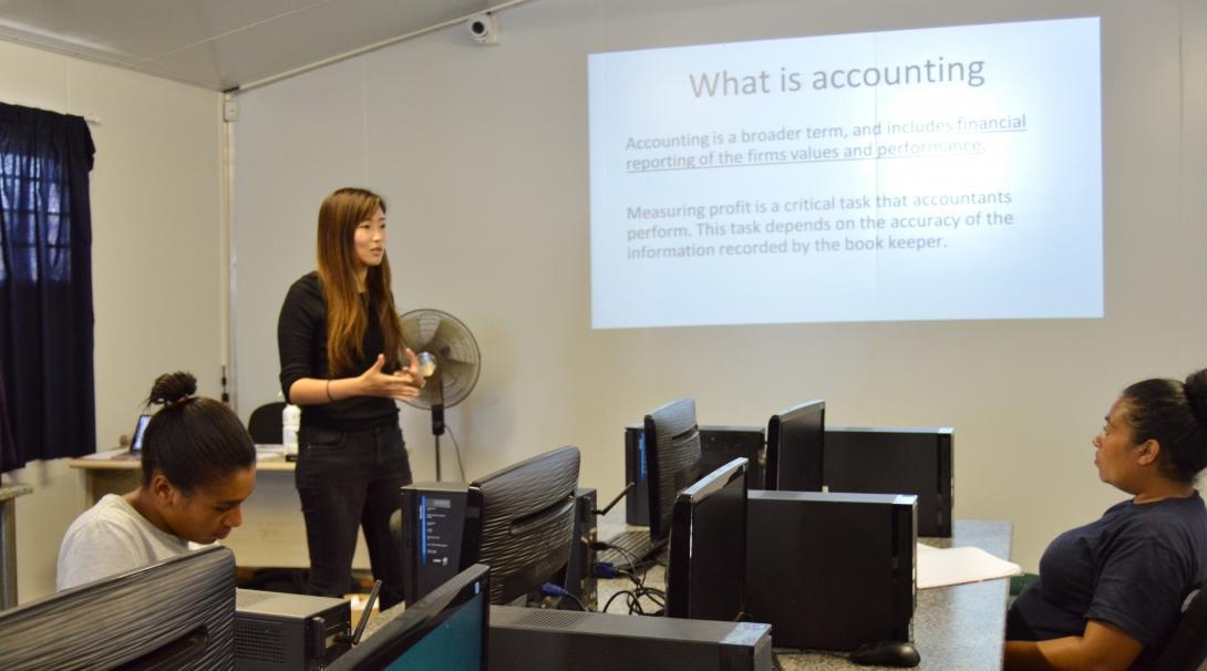 Female International Development Interns presents to other staff what accountancy is during Internship in South Africa.