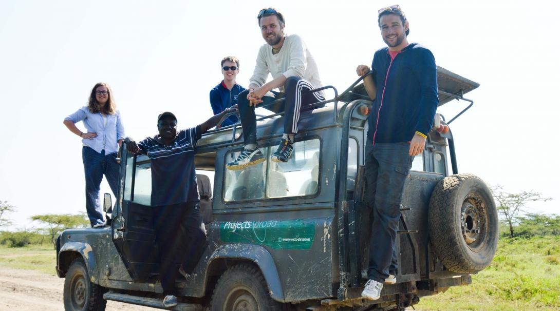 A group of volunteers are pictured on a Jeep truck whilst taking a break from their wildlife conservation volunteering in Kenya with Projects Abroad.