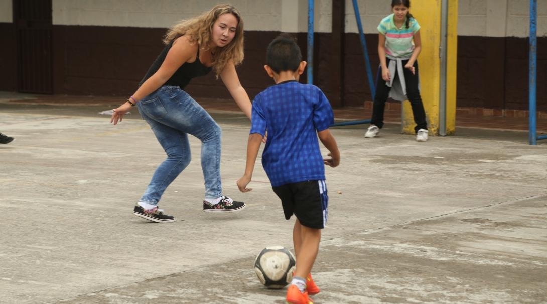 A volunteer teaching sports in Argentina plays ball sports with local children