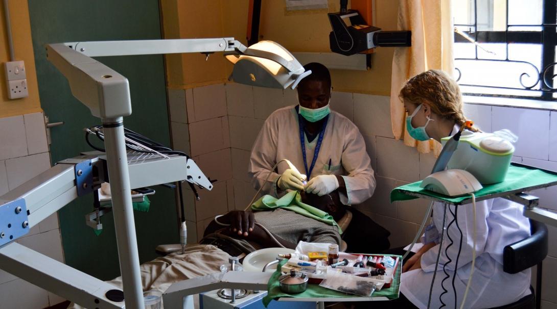 Female Dentistry Intern sits down with a local dentist during a Medicine Internship in Kenya. 