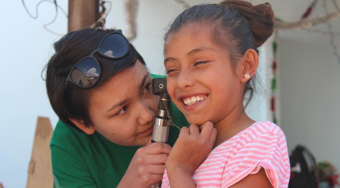 Medical Intern examines a young patients ear during a Medical Community Outreach Day in Mexico.