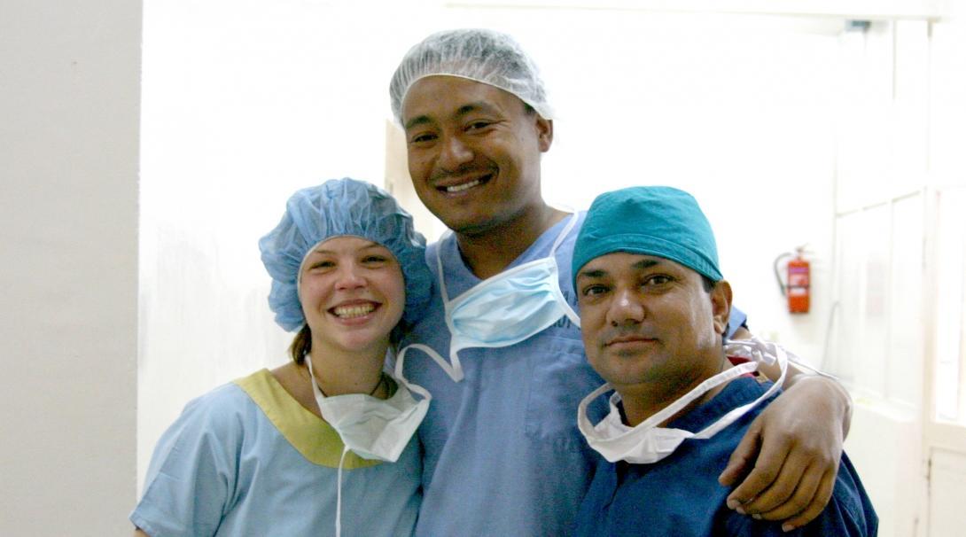 Female Projects Abroad intern taking a photo with local doctors towards the end of her medical internship in Nepal.