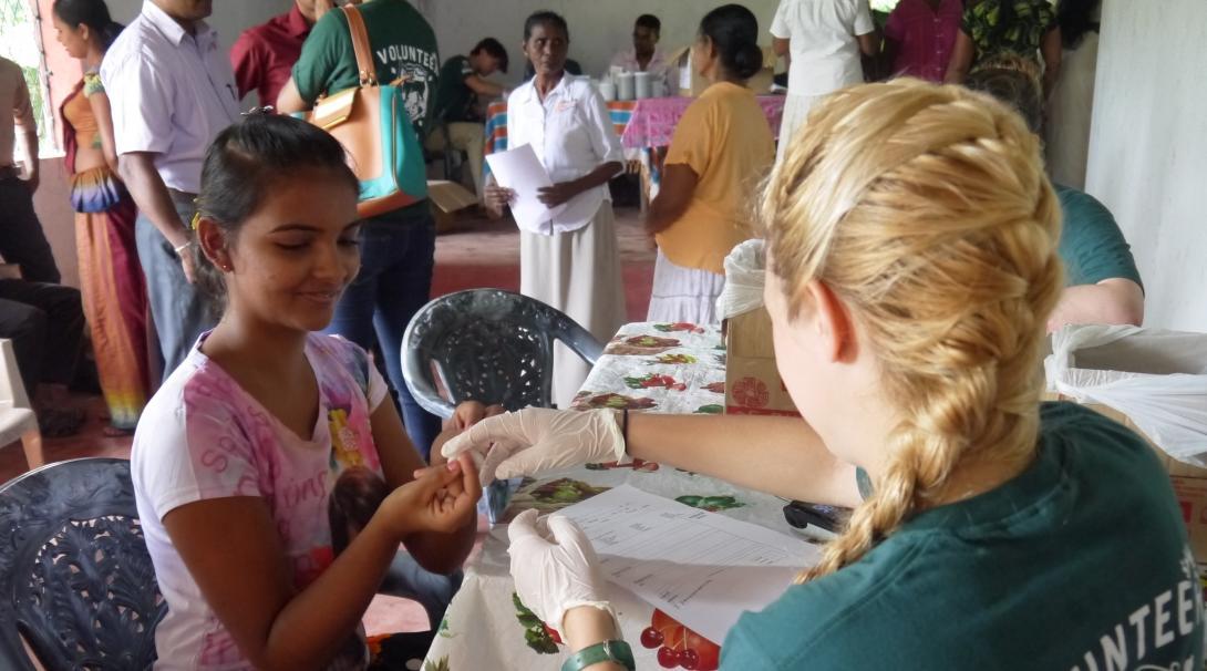 A medical internship student in Sri Lanka is pictured taking blood pressure and sugar levels at a local clinic as she gains vital work experience with Projects Abroad.