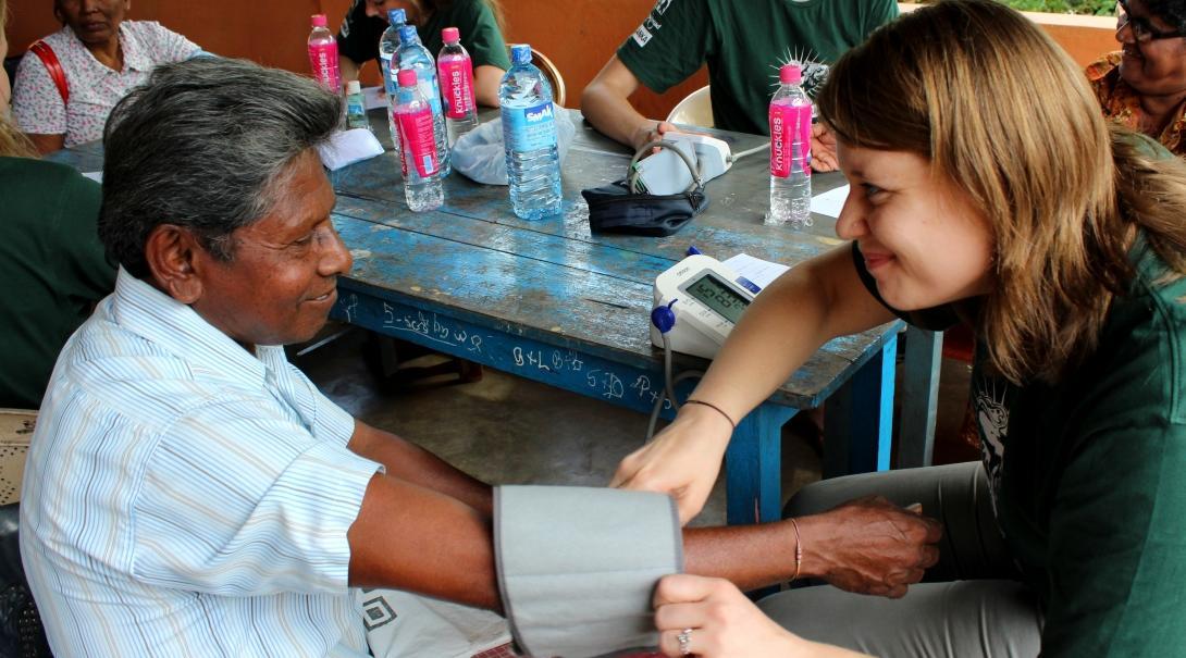 A Projects Abroad female intern can be seen taking blood pressure tests during her medical internship in Sri Lanka.