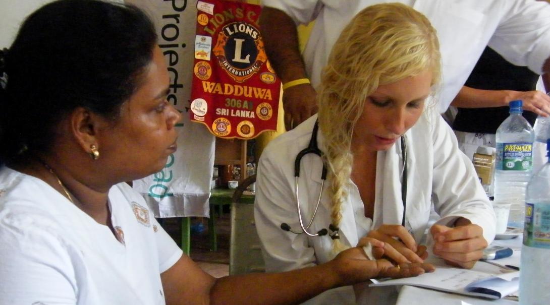 An intern from Projects Abroad is pictured taking blood sugar levels of a local woman whilst undertaking her nursing internship in Sri Lanka.