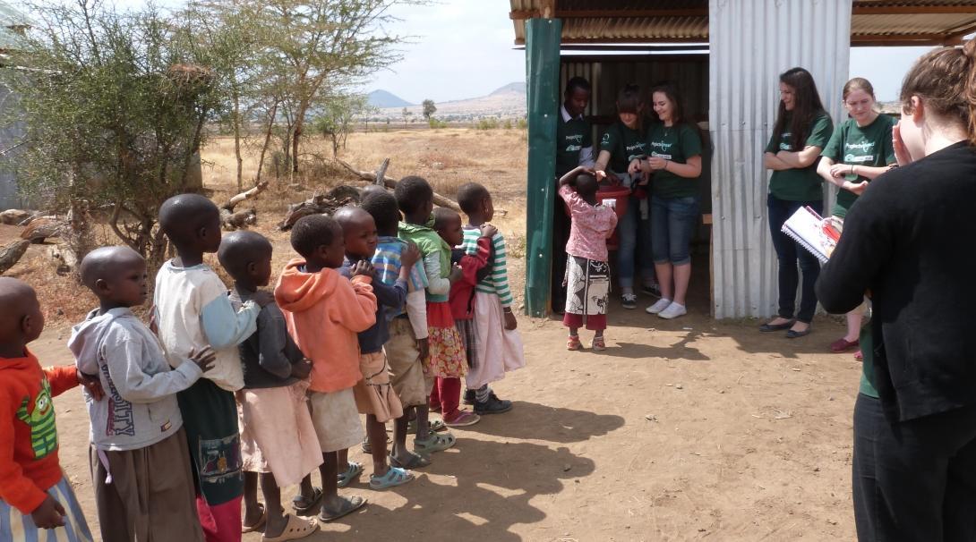 Projects Abroad interns have a queue of children to see at a medical outreach during their medical internship in Tanzania.