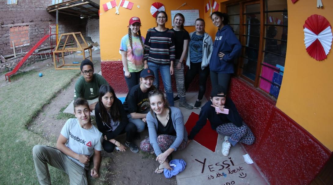 Teenage volunteers doing work with children in Peru, take a break during the day. 