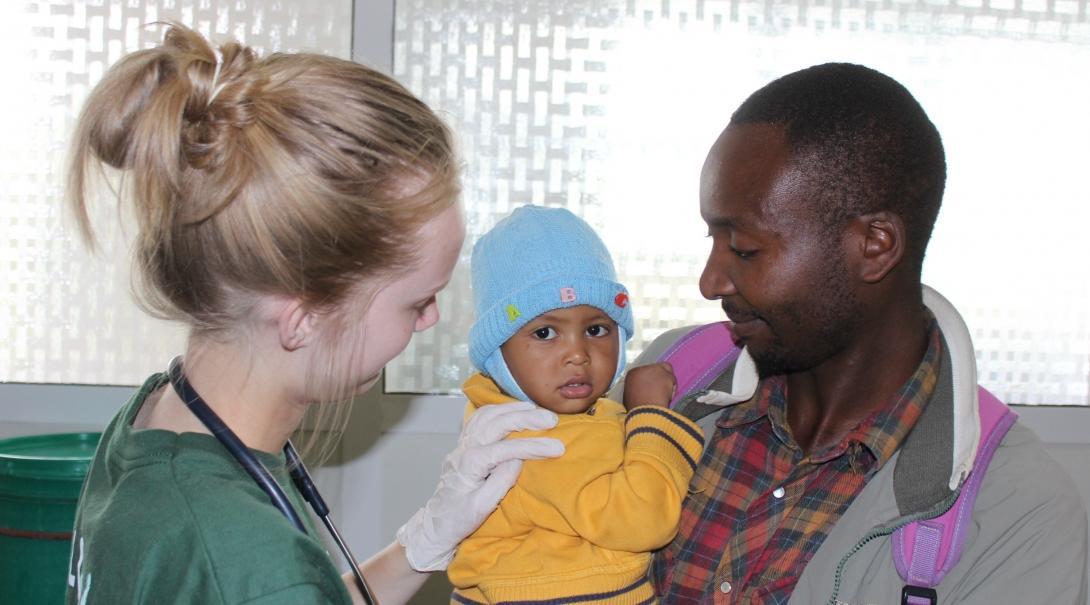 Projects Abroad intern checking a baby's heart beat during her midwifery internship in Tanzania.