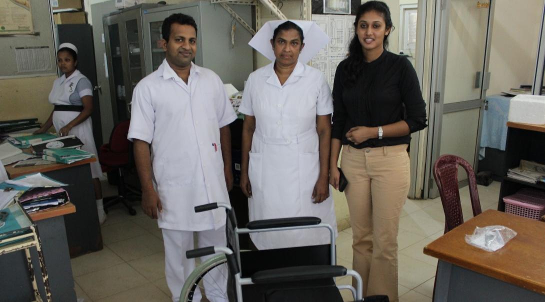 Doctors and nurses take a picture with wheelchair donated by Projects Abroad during an interns Physiotherapy internship in Sri Lanka.