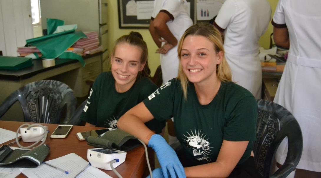 Two medical interns take a break during a community outreach organised by Projects Abroad in Sri Lanka.