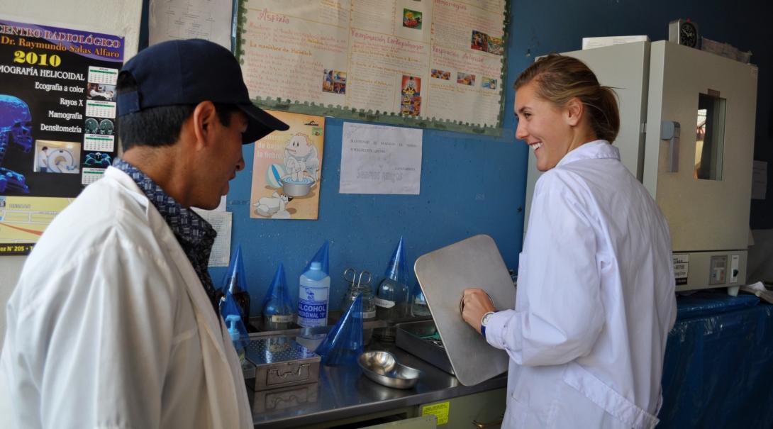 A local doctor and Projects Abroad intern are seen sharing a joke during her medicine and nursing internship in Peru.
