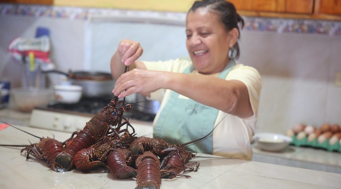 A host mom prepares a meal for her students who live with her while they learn Spanish in Ecuador.   