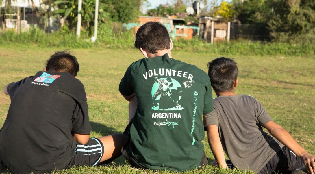 While learning Spanish in Argentina, a student decides to volunteer at a local school and leads an activity outside on the field. 