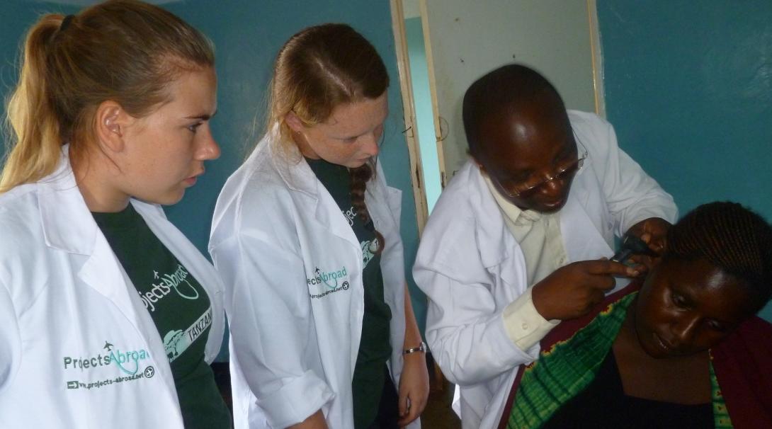 High school students sit in on a consultation during their medical internship in Tanzania