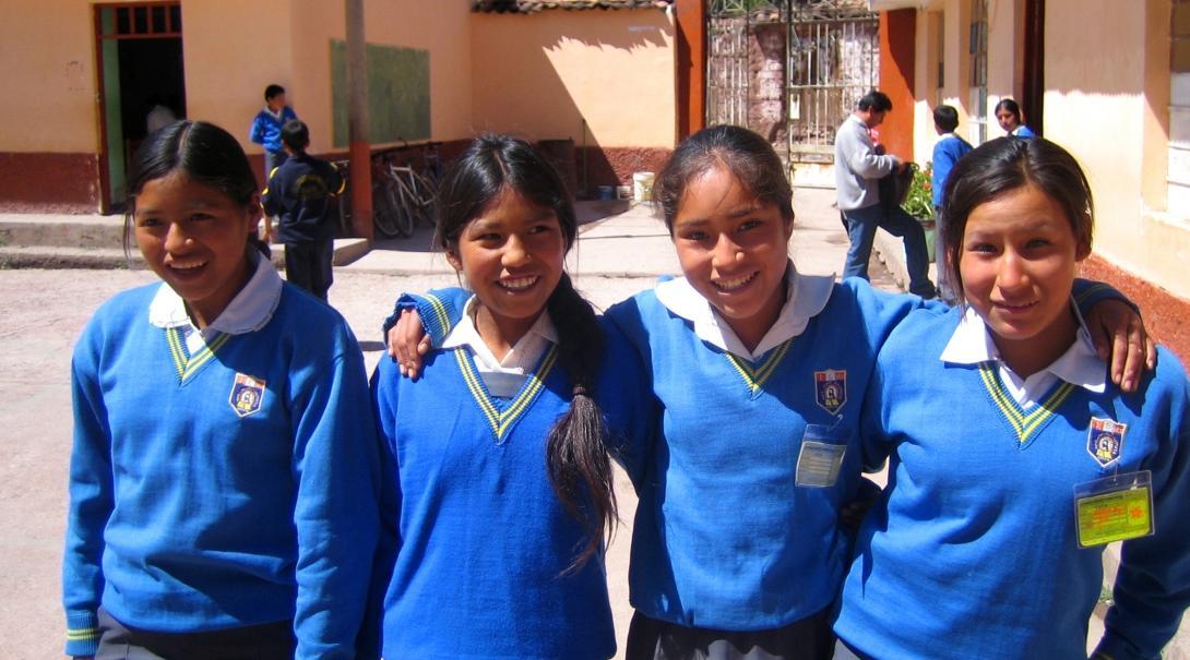 A group of girls pose for a photo outside our volunteer teaching placements in Peru