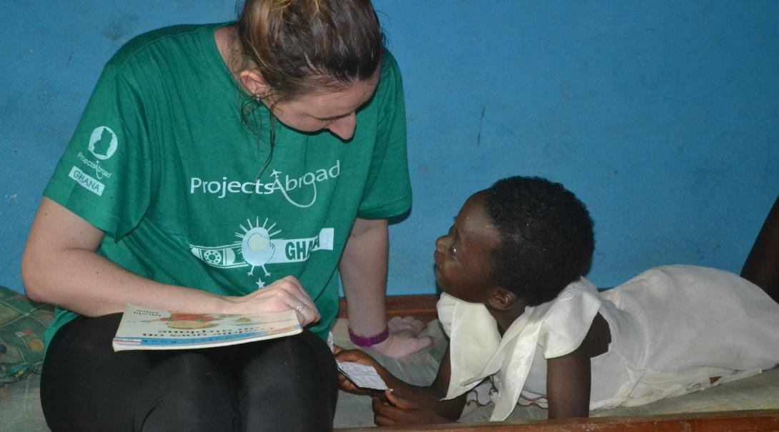 A Projects Abroad intern guides a child during her Social Work internship in Ghana