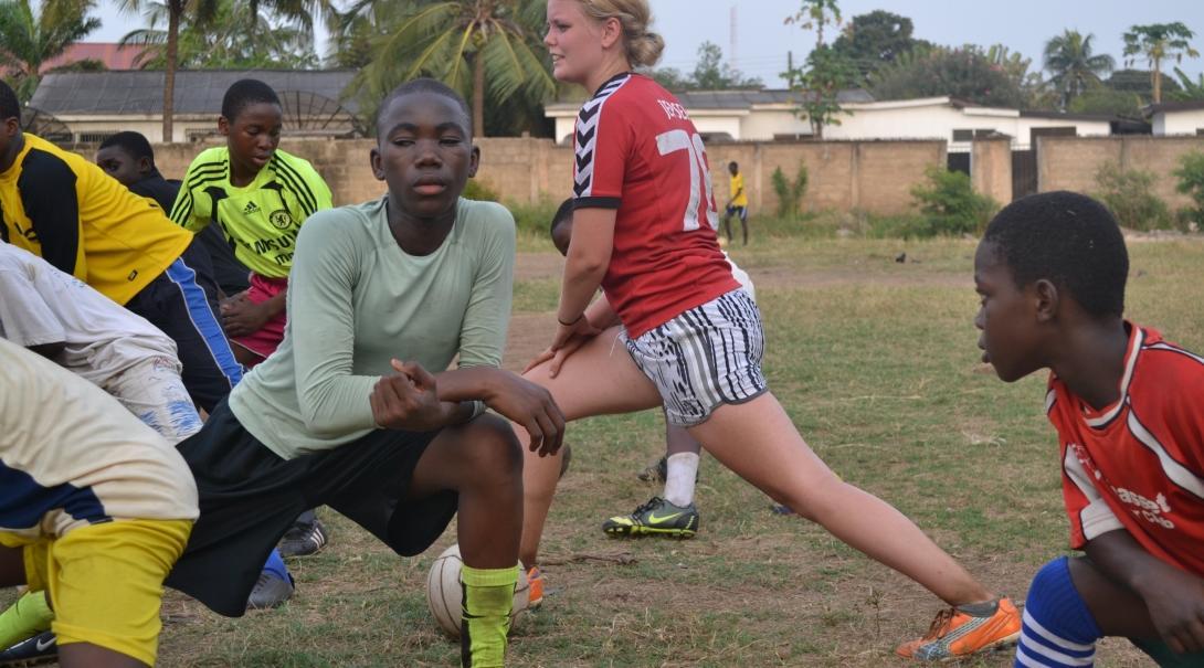A Projects Abroad volunteer warms up before teaching football in Ghana