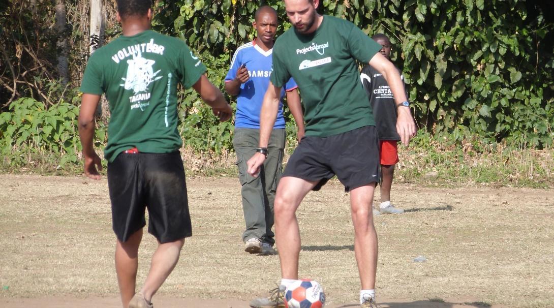 Volunteers practise their passing in preparation to coach sports in schools in Tanzania