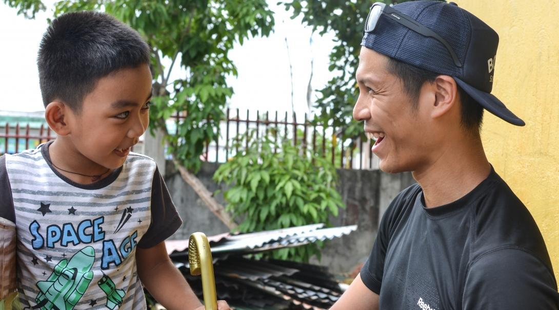 Projects Abroad intern and child pictured sharing a happy moment during his occupational therapy internship in the Philippines.