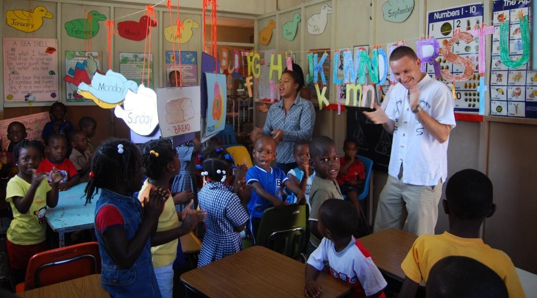 Teaching volunteers in Jamaica sing and dance to an English song with their students