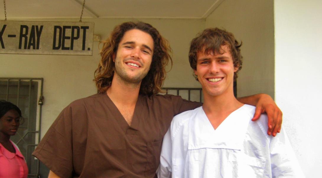 Two male Projects Abroad interns are pictured outside the surgery they have been working in whilst on their physiotherapy internship in Ghana.