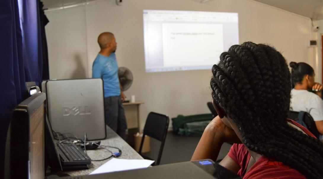 A student pays attention in a class led by a Projects Abroad volunteer teaching IT in South Africa.