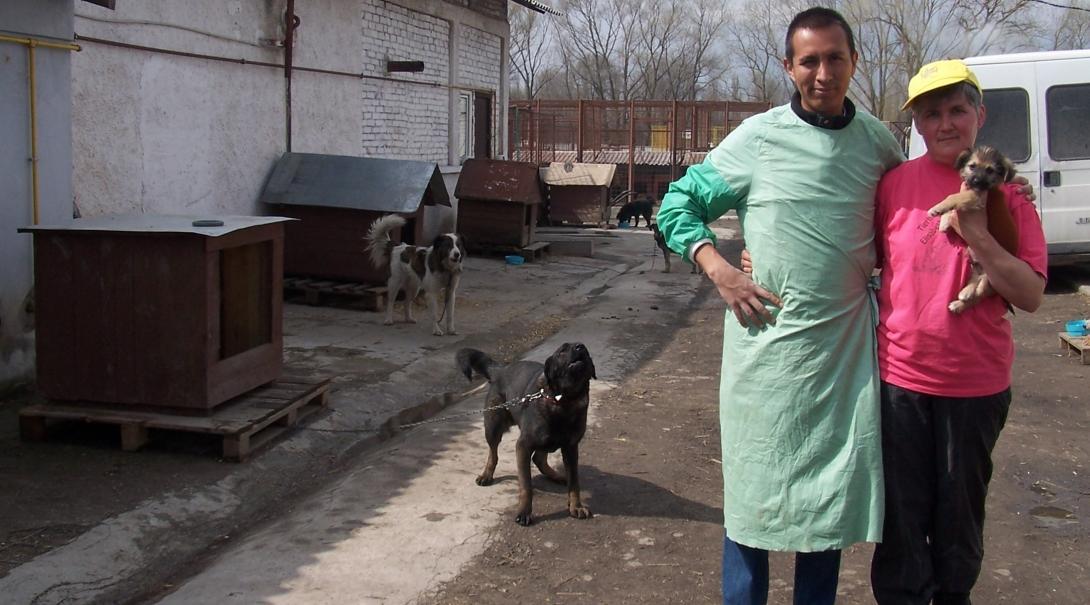 Volunteer and staff member stand outside the Veterinary Medicine placement in Romania.