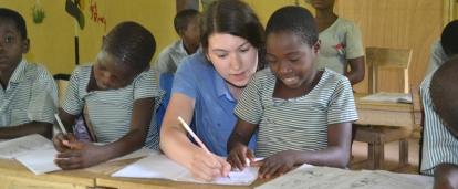 A teacher helps a child at one of our Projects Abroad volunteer teaching placements in Ghana