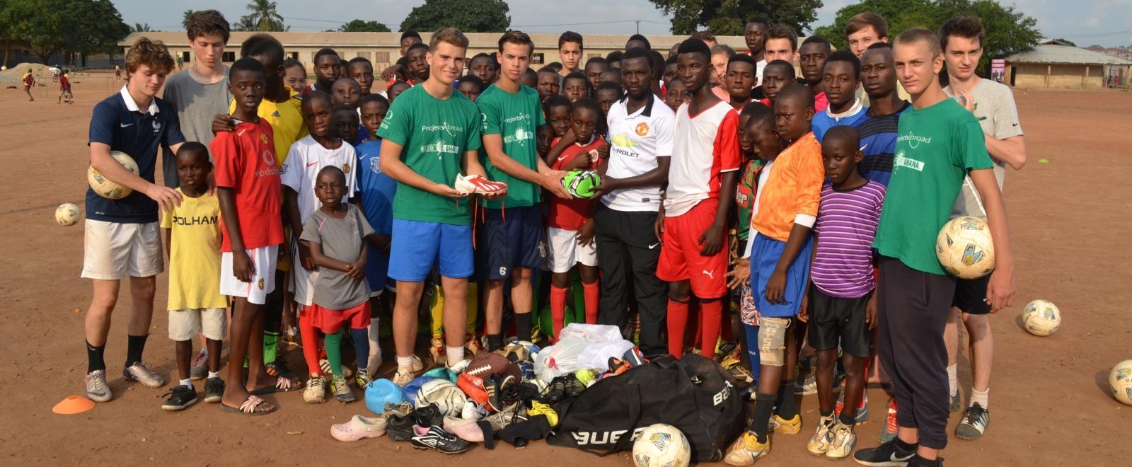 Projects Abroad volunteers taking part in football coaching for high school students in Ghana donate new equipment to a local team. 