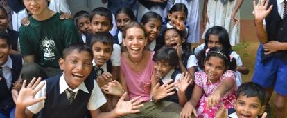 A group of children with Projects Abroad Childcare volunteers outside a kindergarten in Sri Lanka.